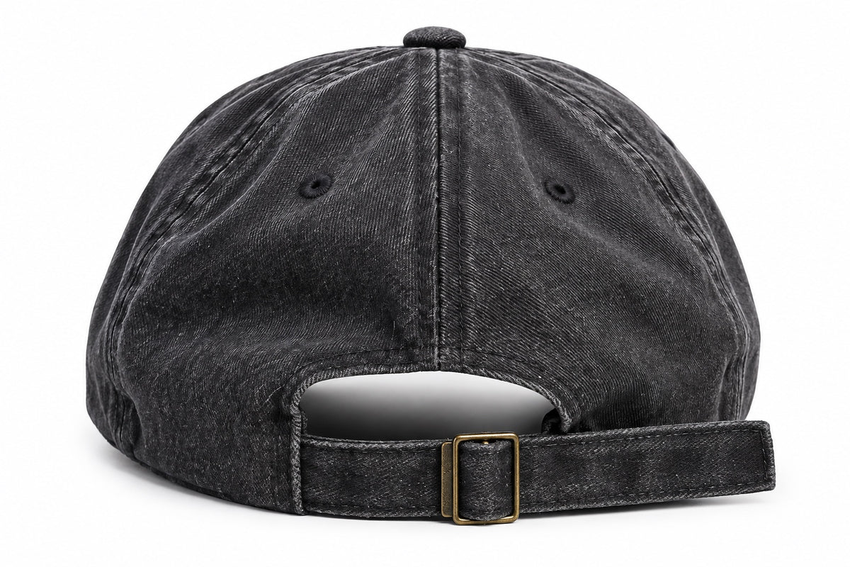 Washed black dad hat showing adjustable back strap and metal buckle