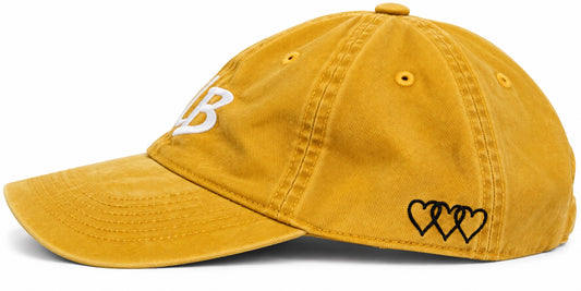 Washed mustard dad hat with three black signature hearts embroidered on side