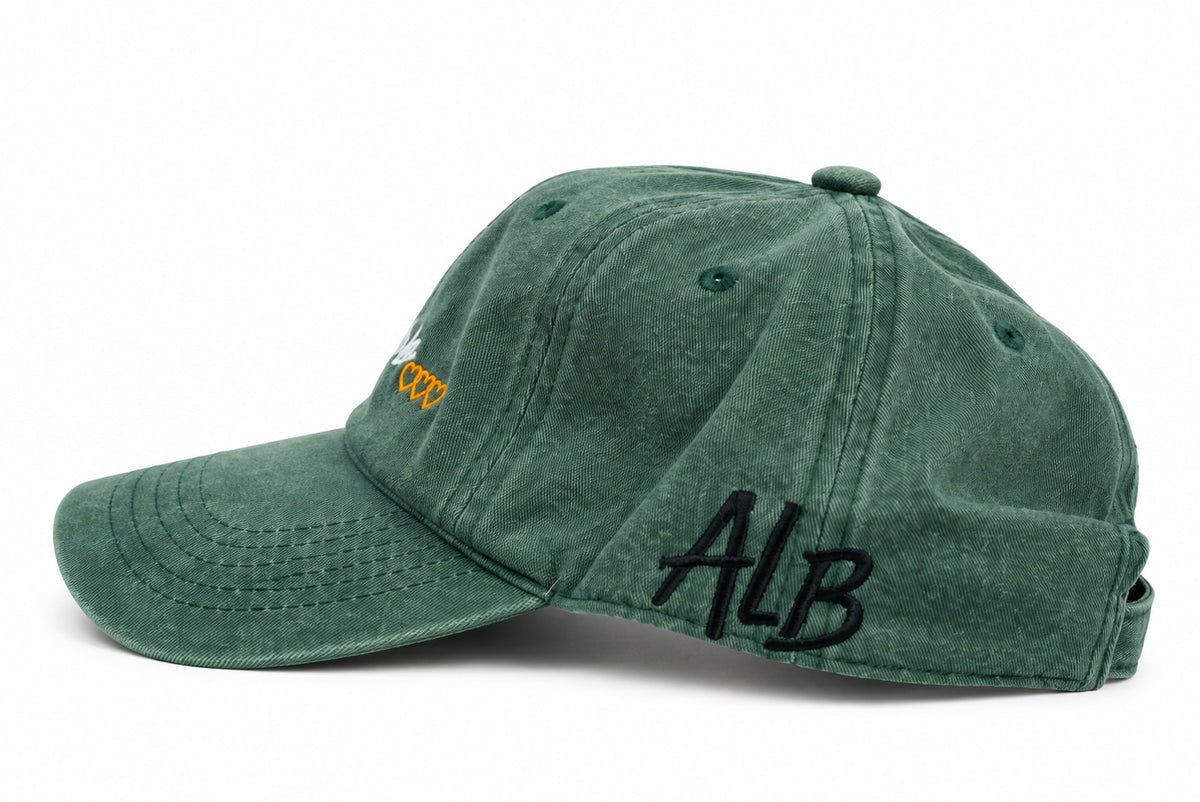 Washed green dad hat with black ALB initials embroidered on side