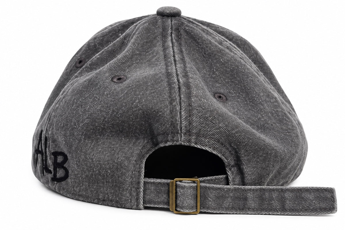 Washed grey dad hat showing adjustable buckle strap and ALB embroidery
