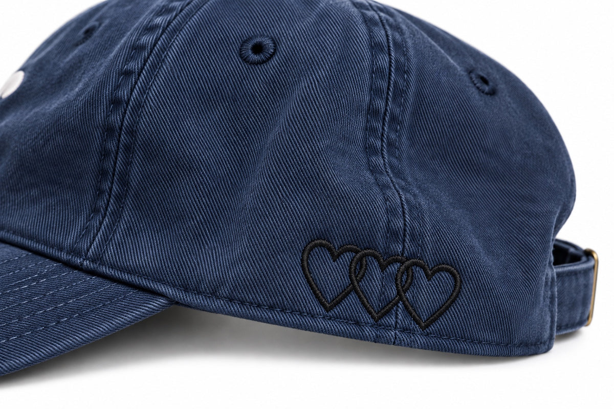 Close-up of three black interlocking signature hearts embroidery