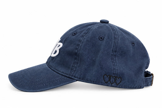 Washed navy dad hat with three black signature hearts embroidered on the side